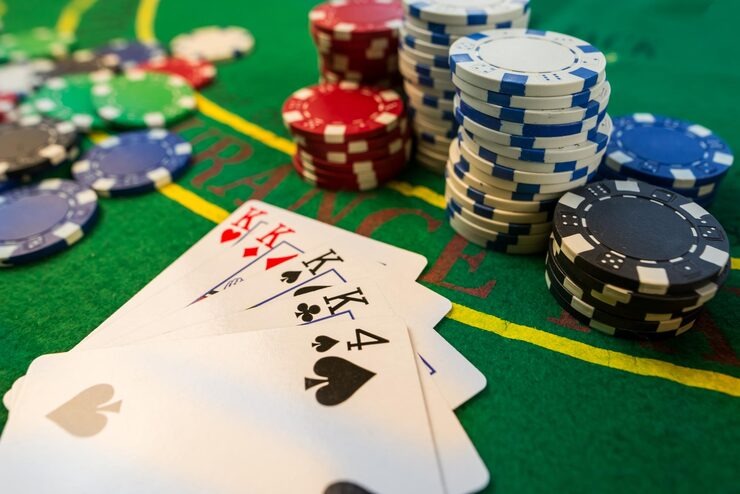 Live Casino Hold'em table with dealer and community cards displayed on screen